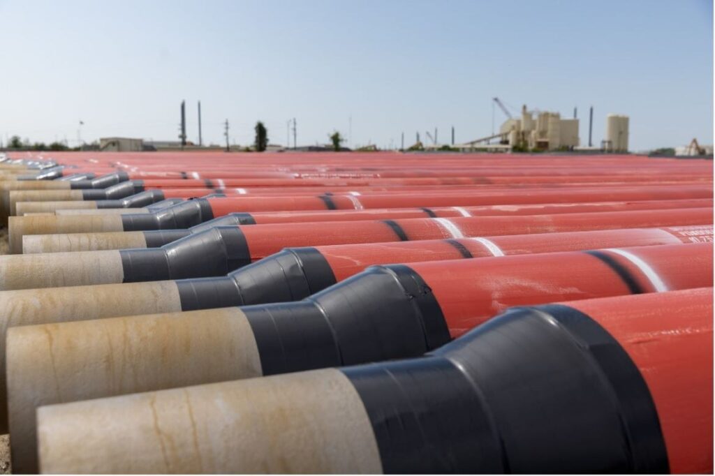 API 5L line pipe with beveled ends stacked in yard