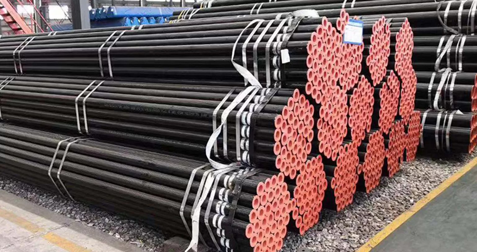 Carbon steel pipe bundles with primed beveled ends in warehouse