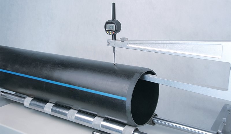 Dial indicator measuring steel pipe diameter