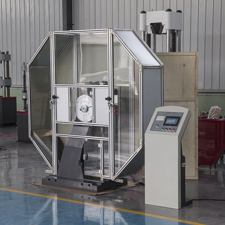 Charpy impact testing machine with safety guard in laboratory